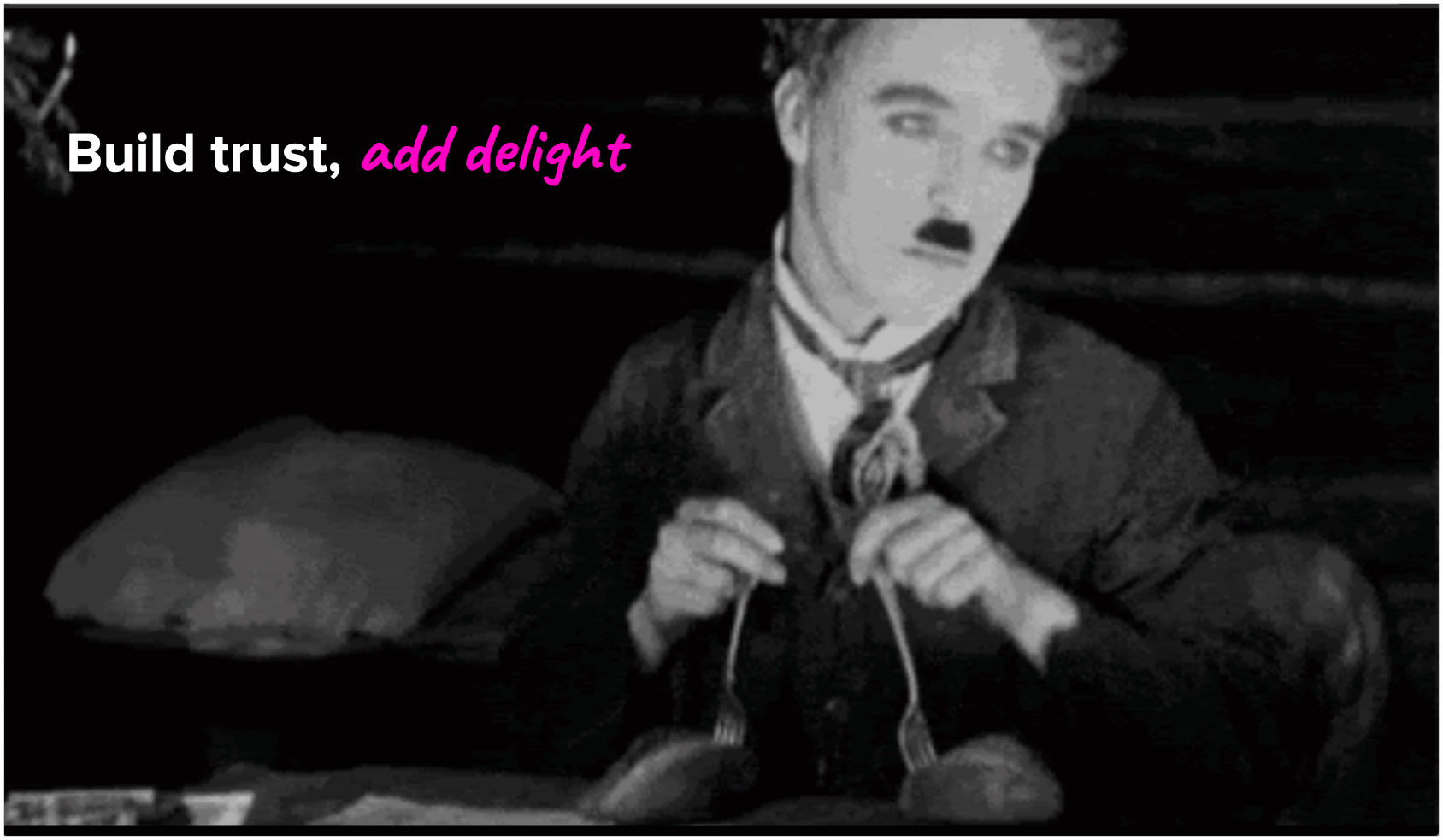 Charlie Chaplin dancing too bread rolls with forks as legs on a table with the words Build trust, add delight written in neon pink handwriting